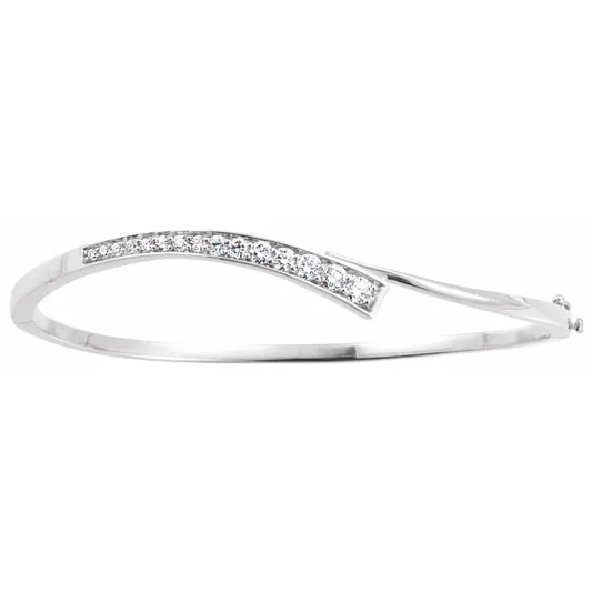 White gold bangle bracelet with a curved design and a row of diamonds set along the curve. The background is white.