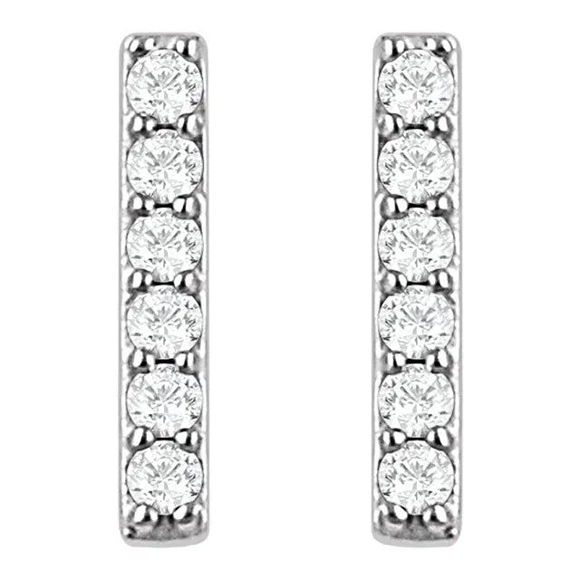 Pair of white gold diamond stud earrings on a white background