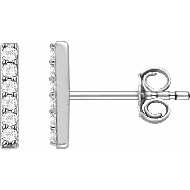 Pair of white gold diamond stud earrings on a white background