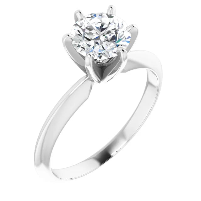 Solitaire diamond engagement ring on a white baqckground.