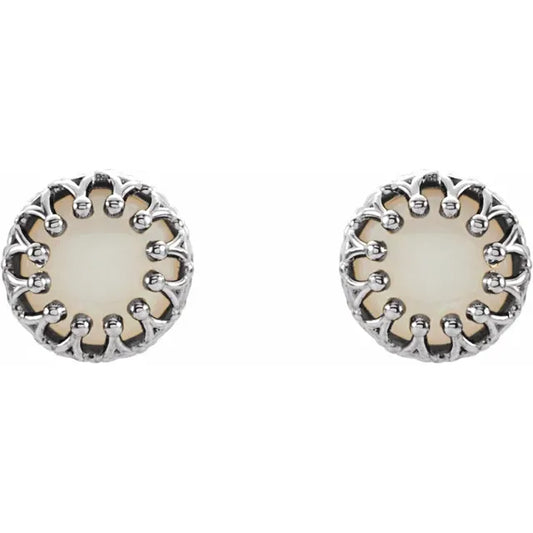 Silver stud earrings with pearl centerpieces on a white background.