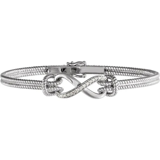 White gold infinity bracelet with diamonds on a white background