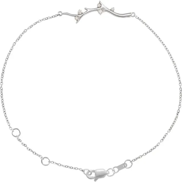 Silver bracelet with a diamond accent branch design on a white background