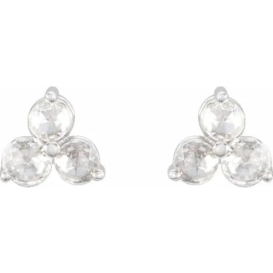 Pair of diamond trefoil stud earrings on a white background