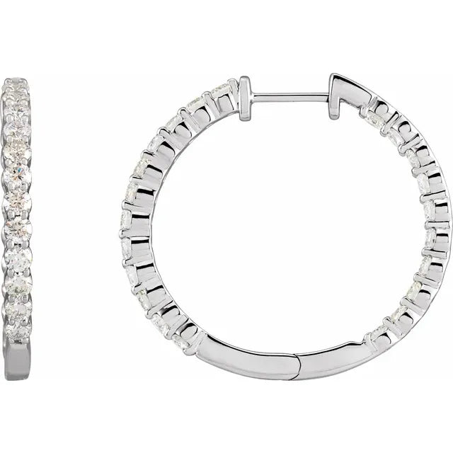 White gold diamond hoop earrings on a white background.