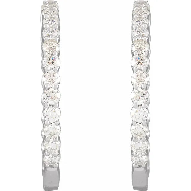 White gold diamond hoop earrings on a white background.