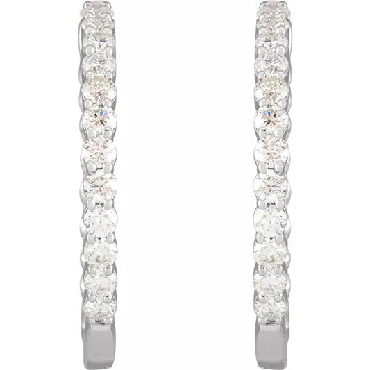 White gold diamond hoop earrings on a white background.