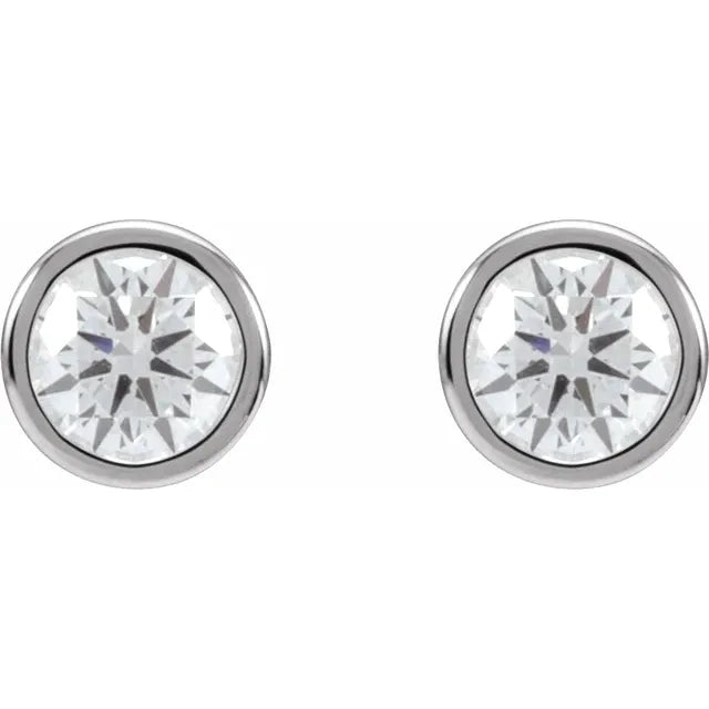 Pair of round diamond stud earrings in white gold, on a white background.