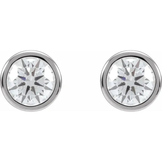 Pair of round diamond stud earrings in white gold, on a white background.