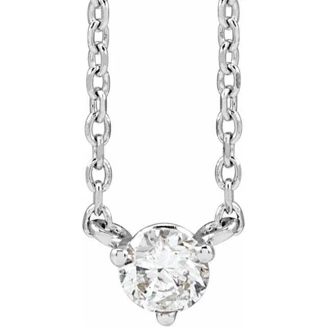 White gold diamond solitaire necklace on a white background.