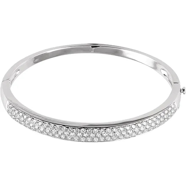 White gold diamond pave bangle bracelet on a white background.