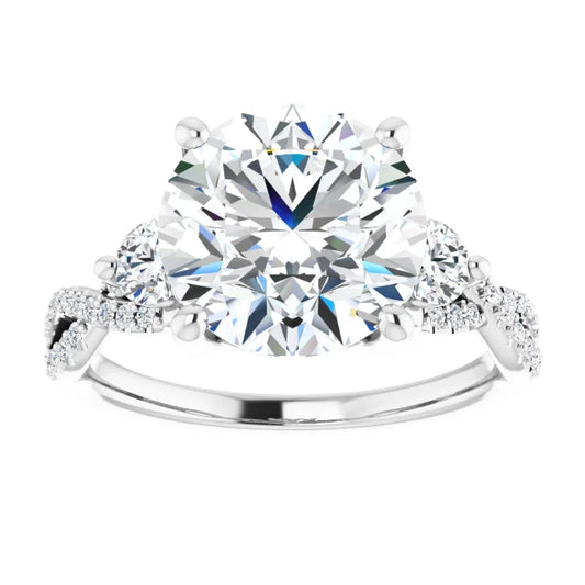 Three-stone diamond engagement ring with a twisted band on a white background 