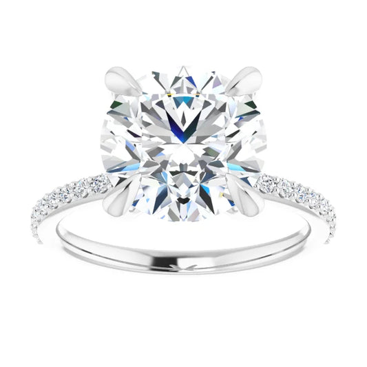 Oval-cut diamond engagement ring with a prong setting and diamond-studded band