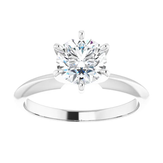 Solitaire diamond engagement ring on a white baqckground.