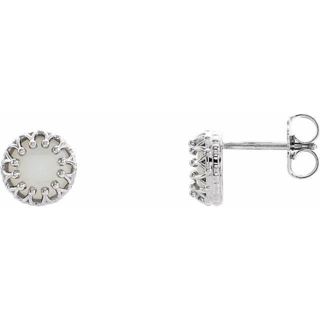 Silver stud earrings with pearl centerpieces on a white background.