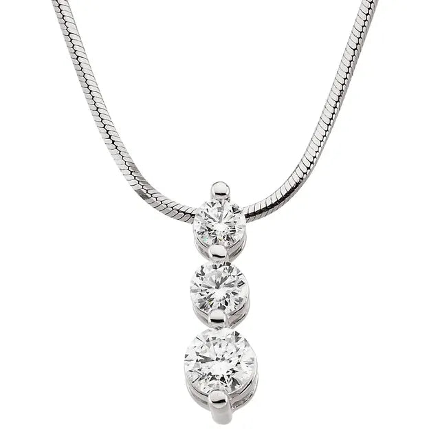 White gold necklace with a pendant featuring three round diamonds arranged in a vertical line, increasing in size from bottom to top. The background is white.