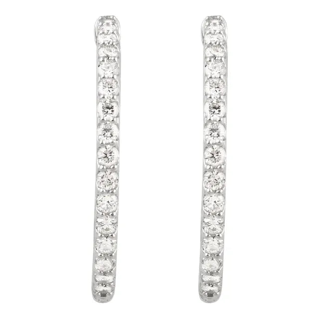 White gold diamond hoop earrings on a white background.