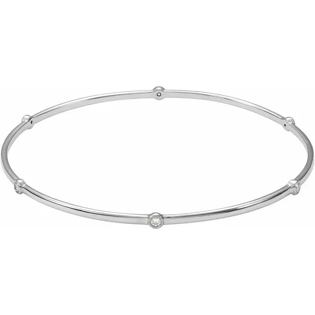 White gold bangle bracelet with diamond accents on a white background.