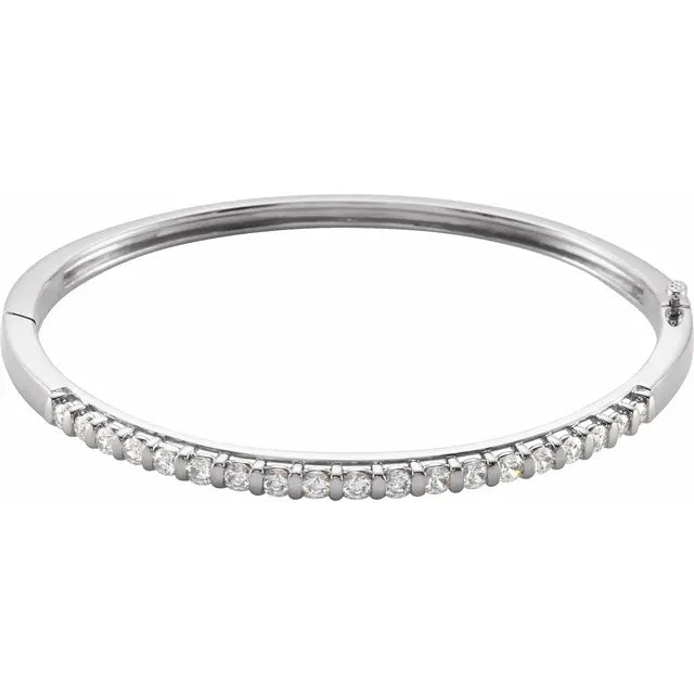 White gold diamond bangle bracelet on a white background.