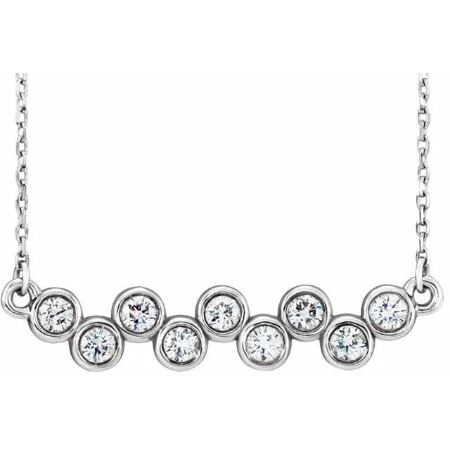 White gold necklace with a row of bezel-set round diamonds on a white background