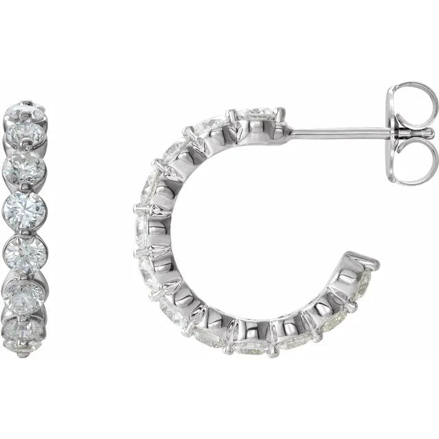 White gold diamond hoop earrings on a white background.