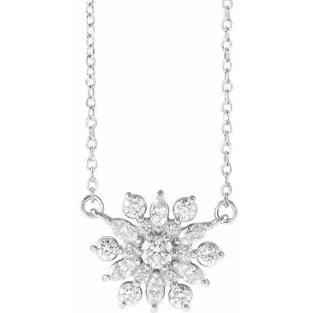 White gold necklace with a diamond pendant shaped like a burst of stars or a flower. The background is white.