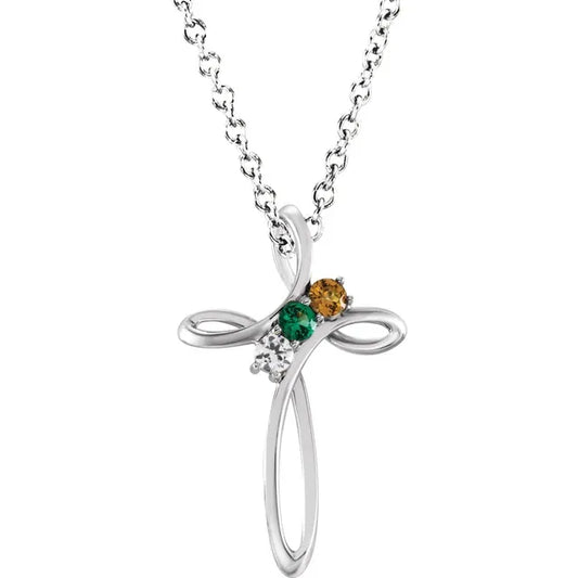 White gold cross necklace with three gemstones on a white background.