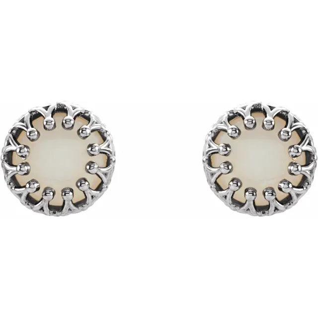 Silver stud earrings with pearl centerpieces on a white background.