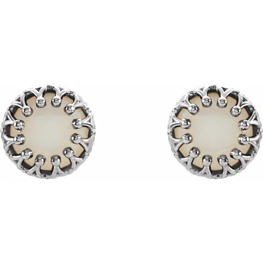 Silver stud earrings with pearl centerpieces on a white background.