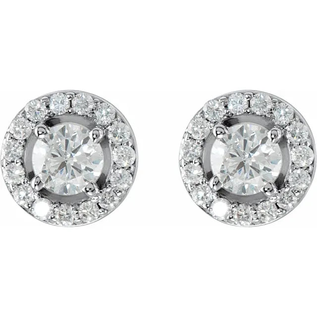 Pair of diamond halo stud earrings in white gold, on a white background.