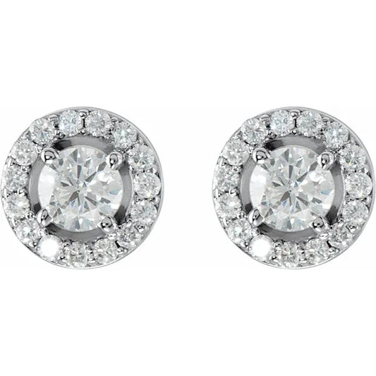 Pair of diamond halo stud earrings in white gold, on a white background.