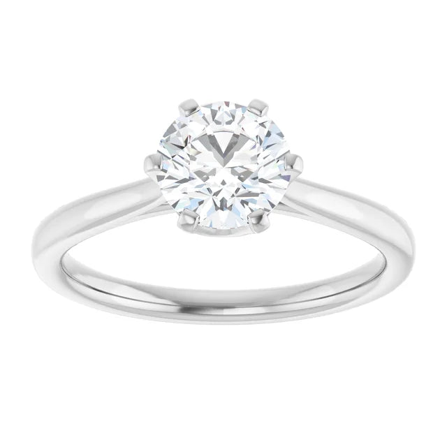 White gold solitaire diamond engagement ring on a white background.