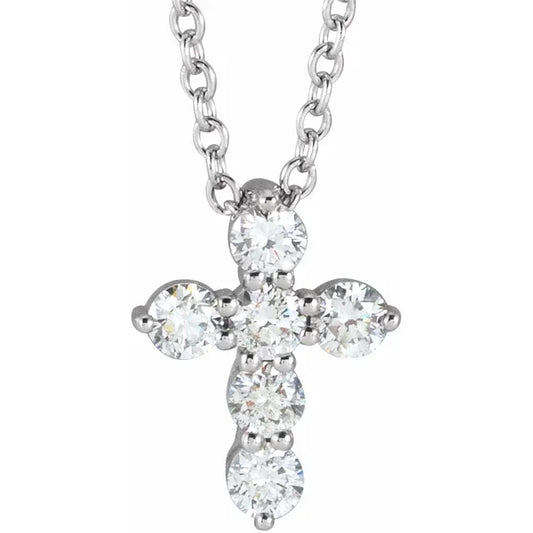 White gold diamond cross necklace on a white background.