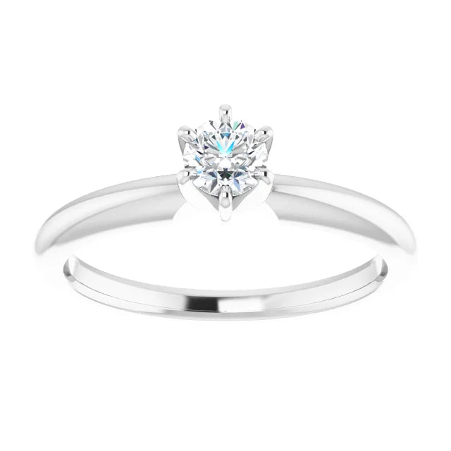 White gold solitaire diamond engagement ring on a white background