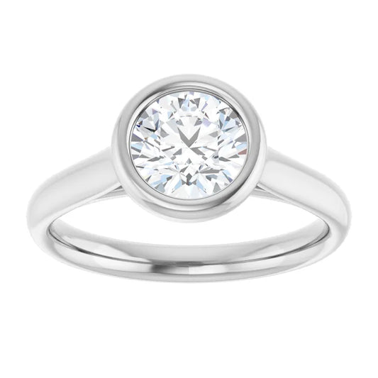  White gold bezel-set diamond engagement ring on a white background.