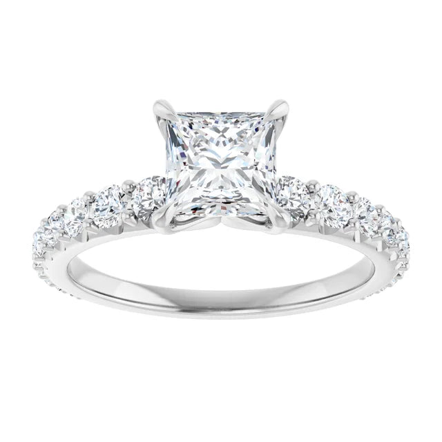 White gold three-stone diamond engagement ring on a white background.