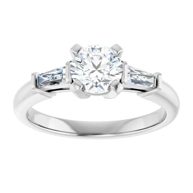 White gold three-stone diamond engagement ring with baguette side stones on a white background.