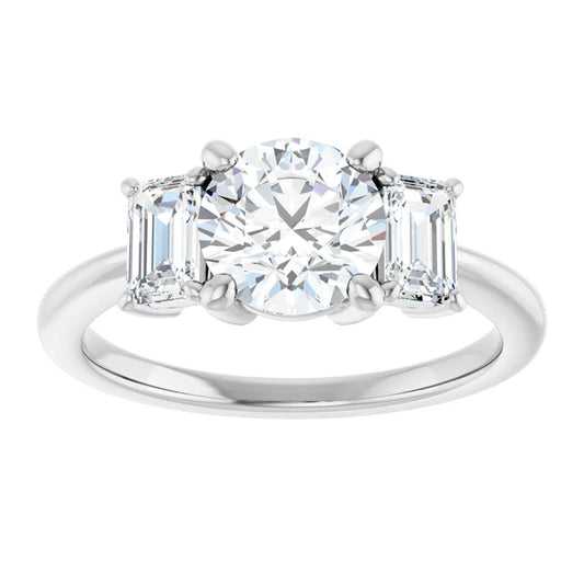 White gold three-stone diamond engagement ring with emerald-cut side stones on a white background.