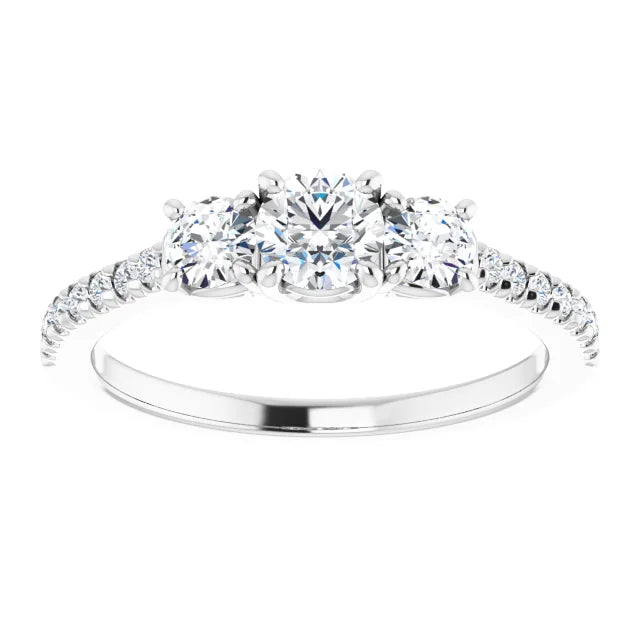 White gold three-stone diamond engagement ring with a diamond band on a white background.