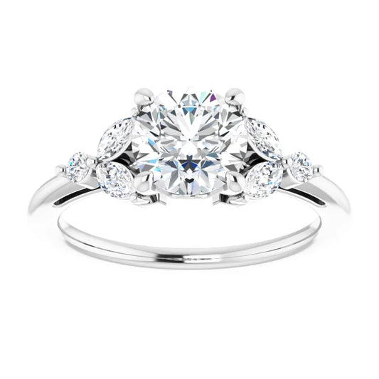 White gold ring with a large round diamond in the center, surrounded by smaller marquise-shaped diamonds. The background is white.