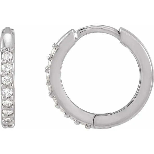 White gold diamond hoop earrings on a white background.