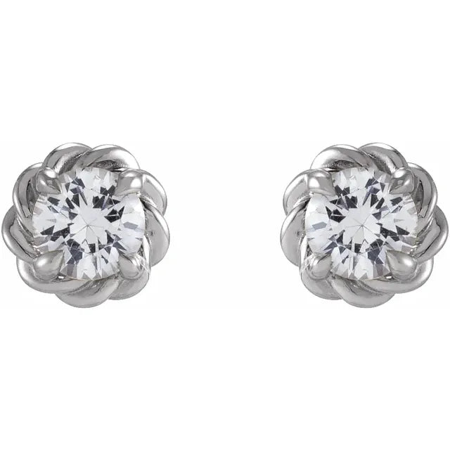 White gold diamond stud earrings on a white background