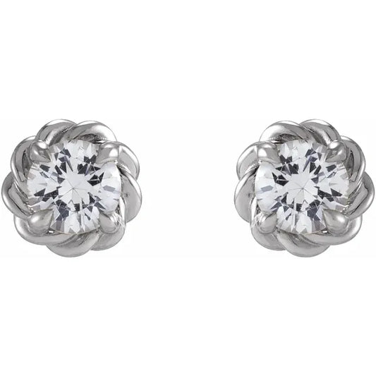 White gold diamond stud earrings on a white background