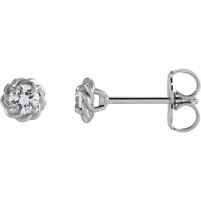 White gold diamond stud earrings on a white background