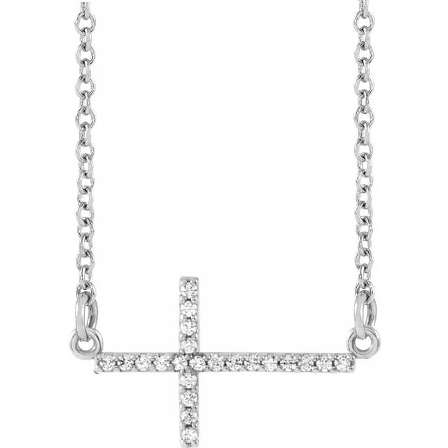 White gold diamond cross necklace on a white background.