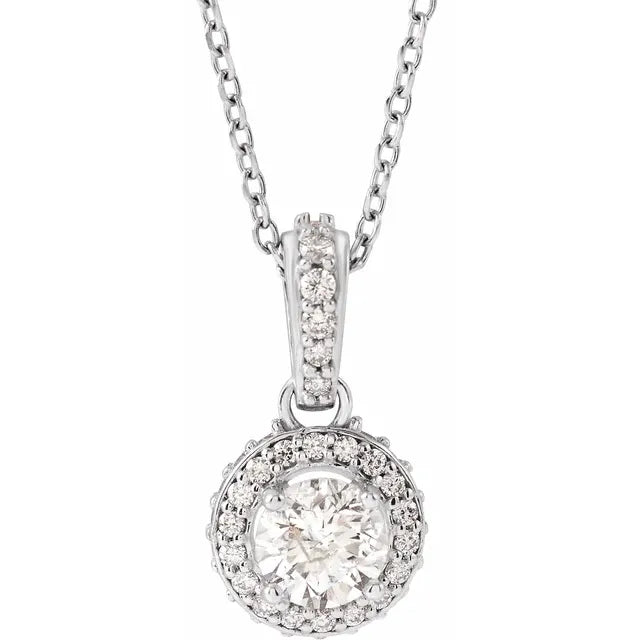 Silver necklace with a round diamond pendant surrounded by a halo of smaller diamonds. The background is white.