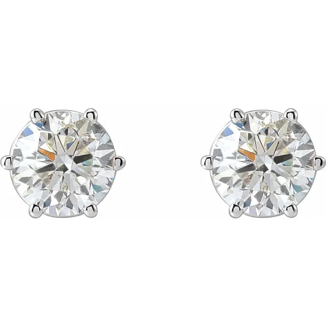 Pair of diamond stud earrings on a white background