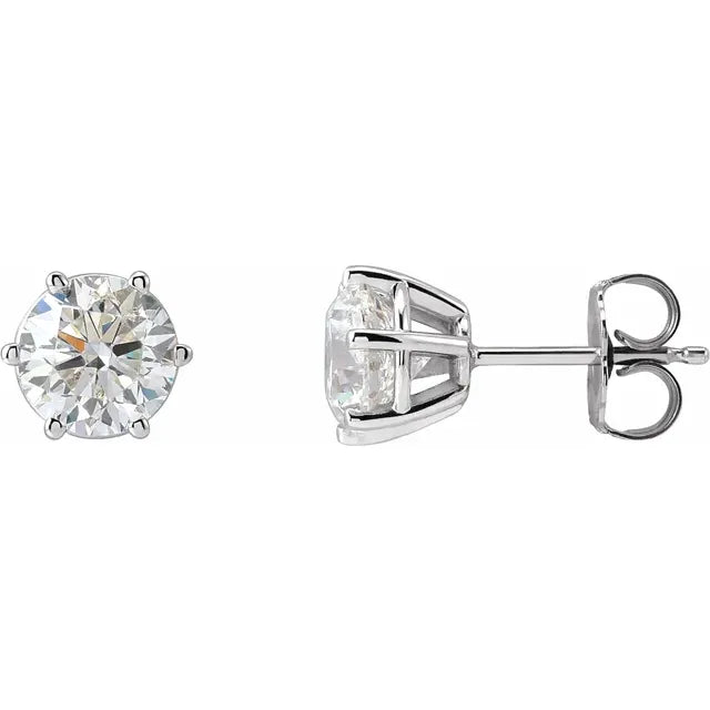 Pair of diamond stud earrings on a white background