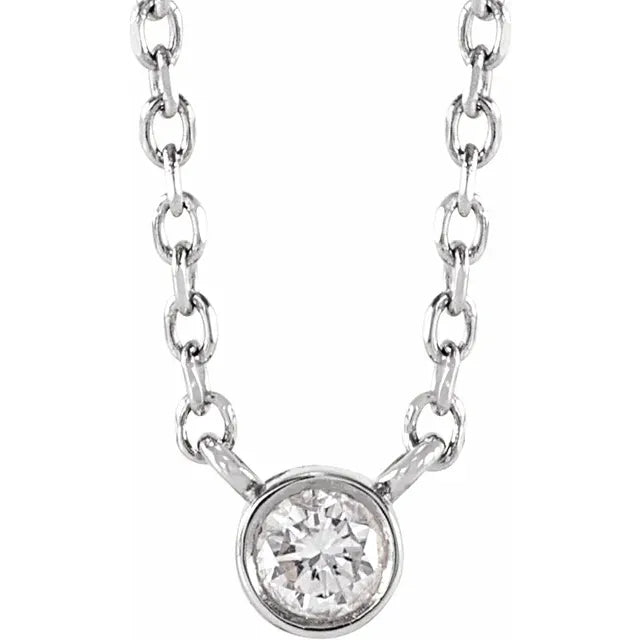 White gold bezel-set diamond pendant necklace on a white background.