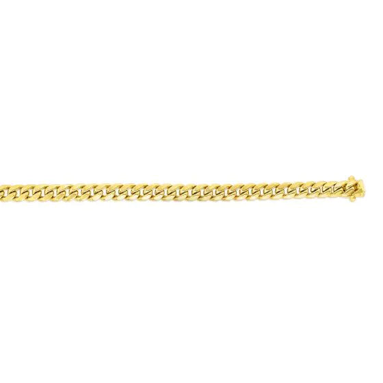 Yellow gold cuban link chain on a white background.